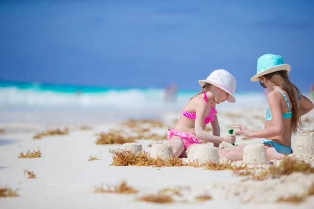 Adorable little girls at beach during summer vacation