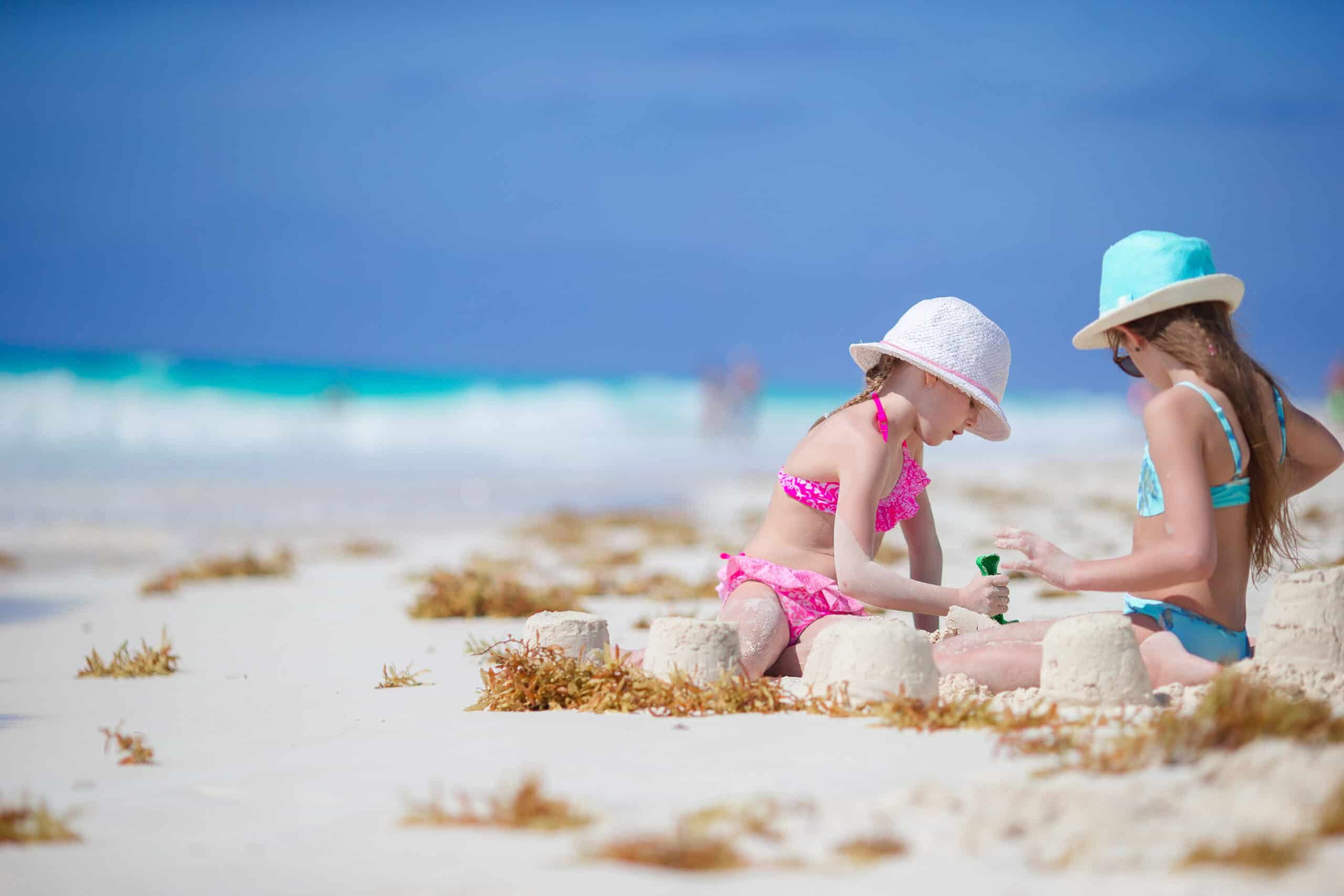 Adorable little girls at beach during summer vacation