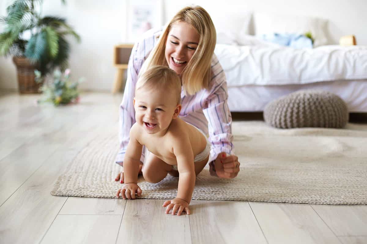 mom crawling on floor with baby