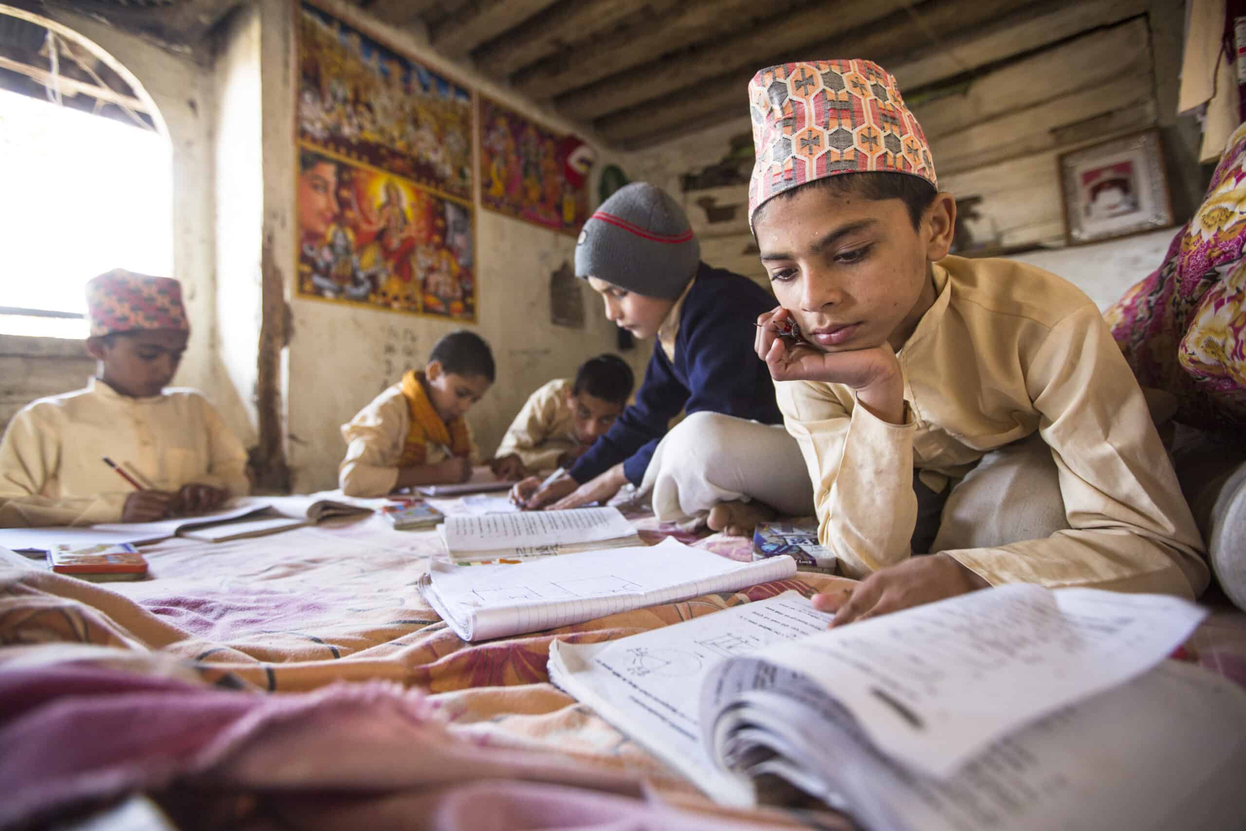 KATHMANDU, NEPAL - DEC 9, 2013: Unknown children doing homework at Jagadguru School. School established at 2013, to let new generation learn Sanskrit and preserve Hindu culture.