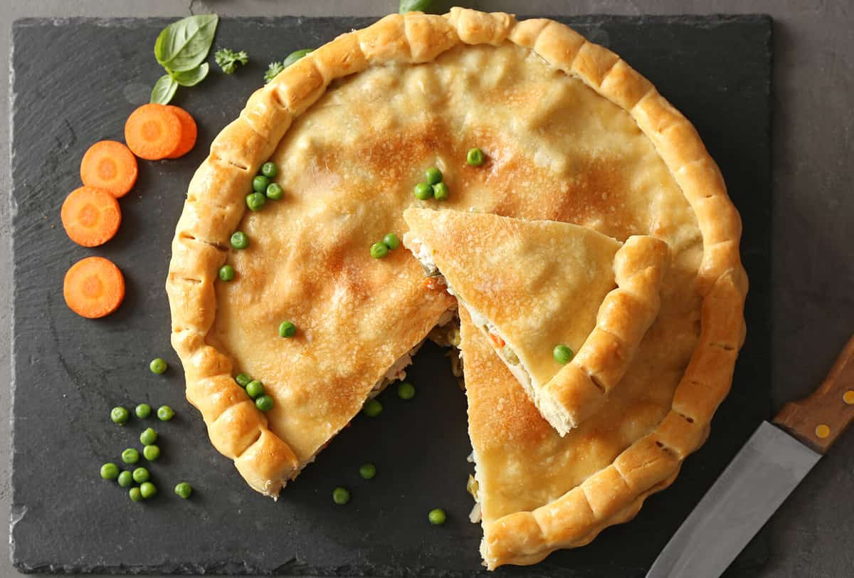 Composition with delicious turkey pot pie on gray table