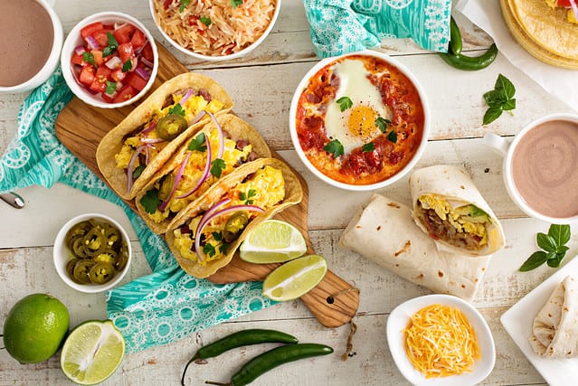 Variety of colorful mexican cuisine breakfast dishes on a table
