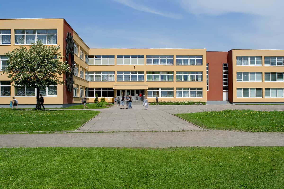 Public school building. Exterior view of school building with playground.