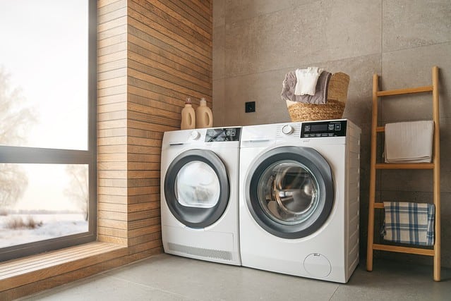 Interior of a real laundry room with a washing machine at home