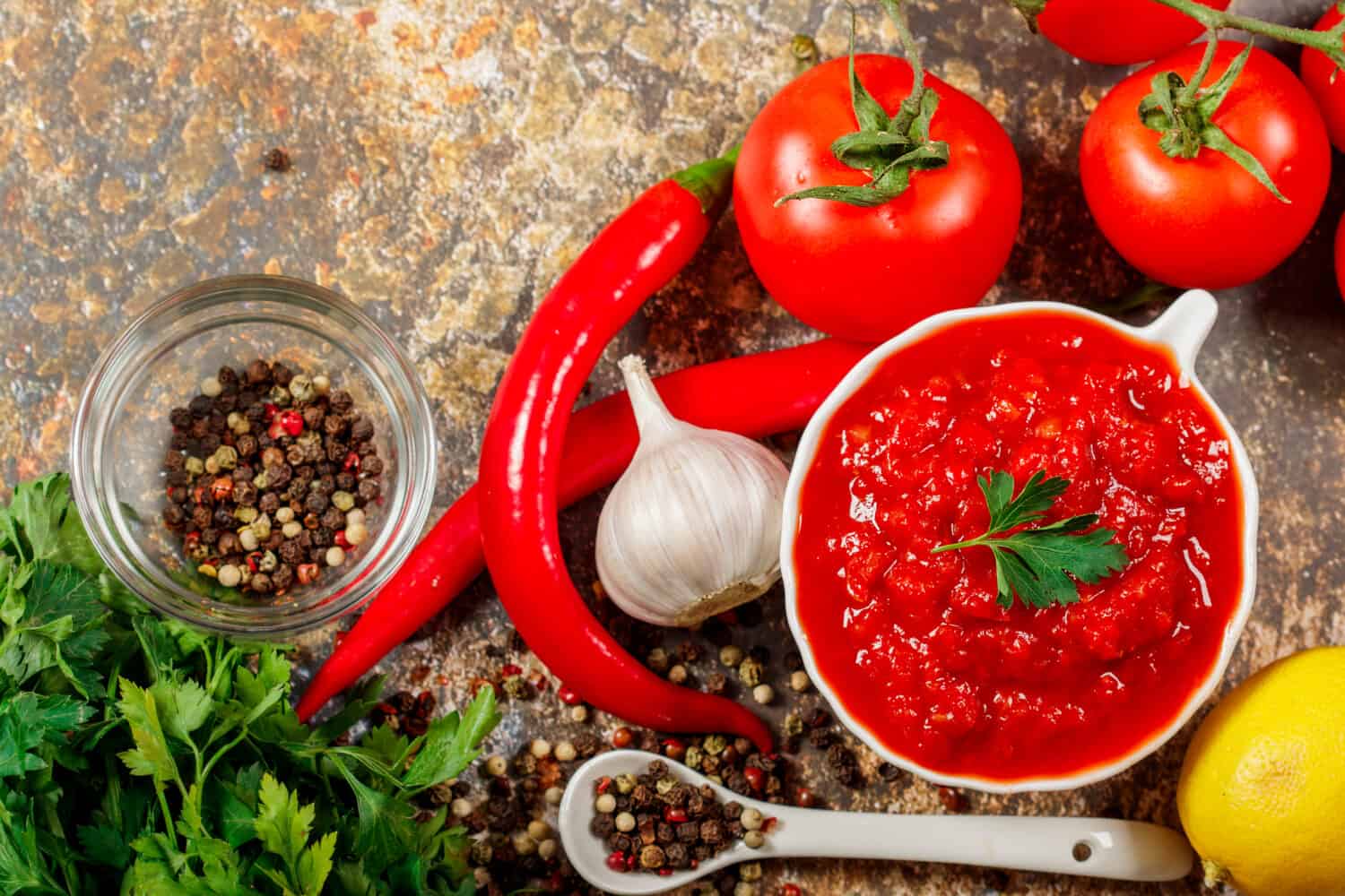 Salsa Sauce. Spicy, colorful Mexican salsa sauce with hot peppers and tomatoes on a dark background.Classic homemade Italian tomato sauce for pasta pizza in on wooden background.