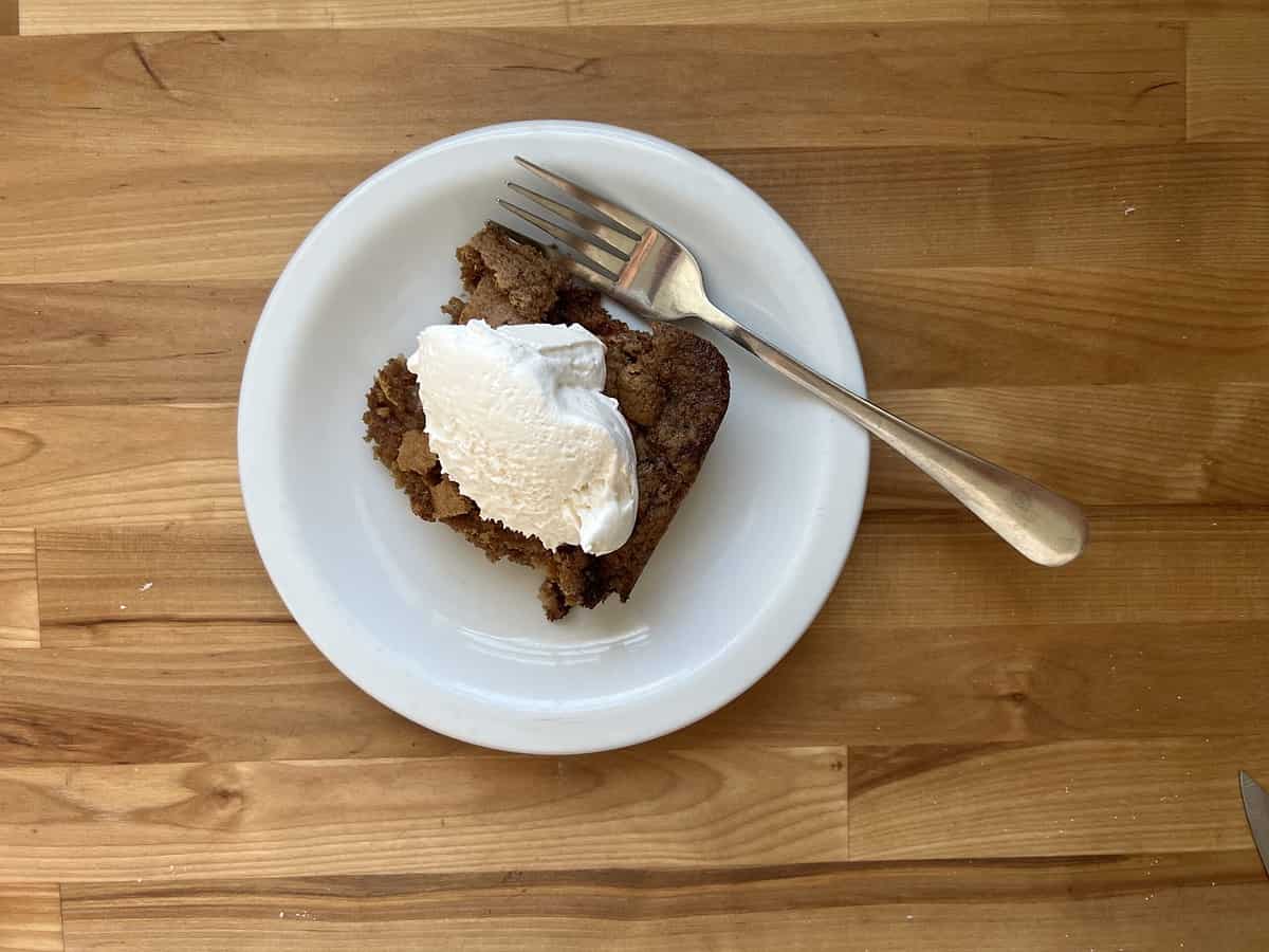 Slice of fresh apple dump cake with whipped cream