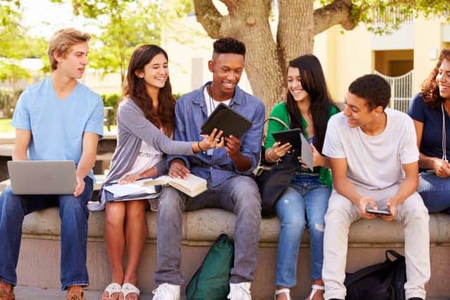 High School Students Collaborating On Project On Campus