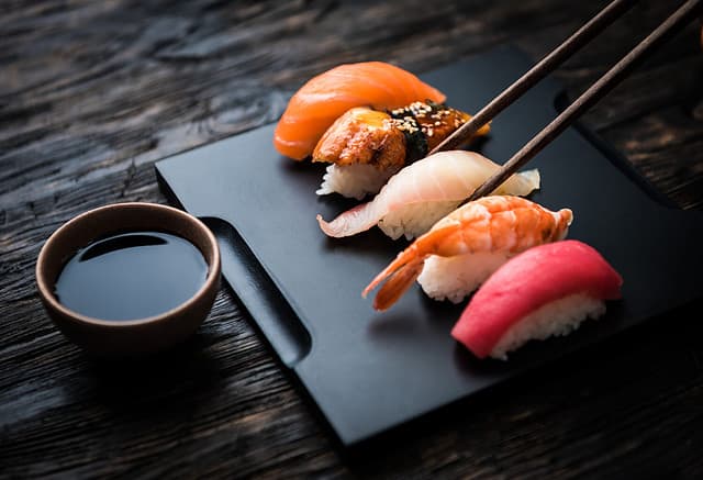 close up of sashimi sushi set with chopsticks and soy