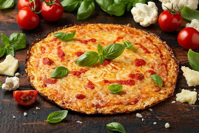 Cauliflower crust pizza with tomato sauce, cheese and basil. Healthy diet food