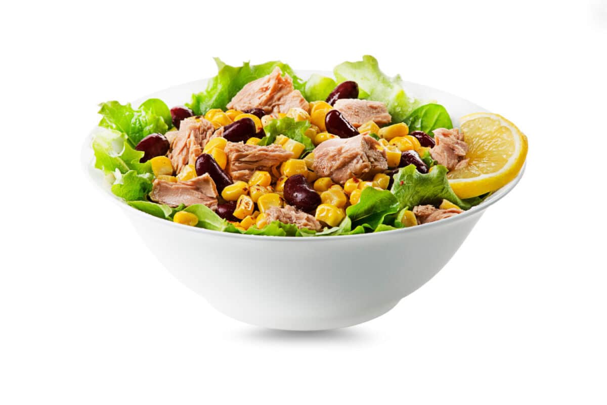 Healthy Green salad with tuna, corn and beans isolated on white background. Mexican corn salad.