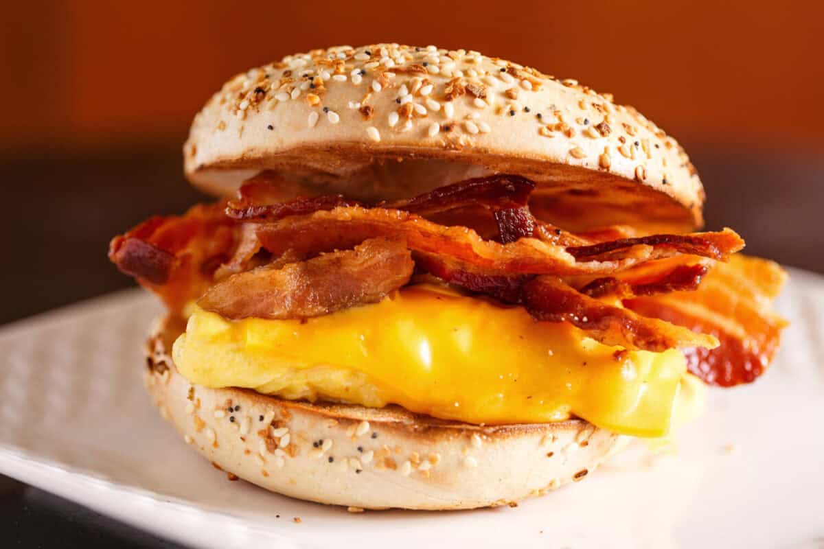 Close-up of a egg, bacon and cheese sandwich on a sesame seed bagel