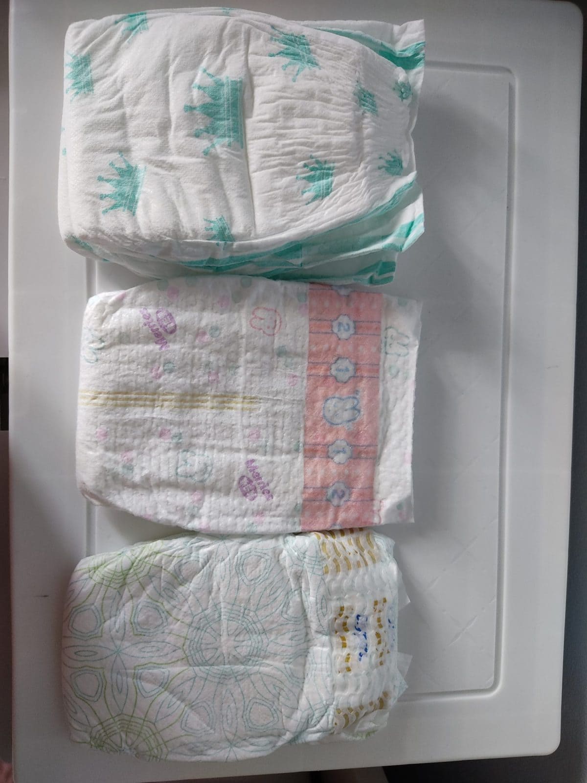 three different sizes of diapers from three different brands. Treatment options for diaper rash.