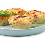 Freshly baked bacon and egg muffins with cheese isolated on white