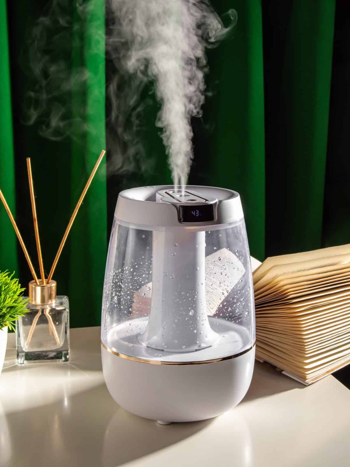 Humidifier or electric aroma diffuser on dark green background. Living room or bedroom. Steam. Treatment for strep throat.