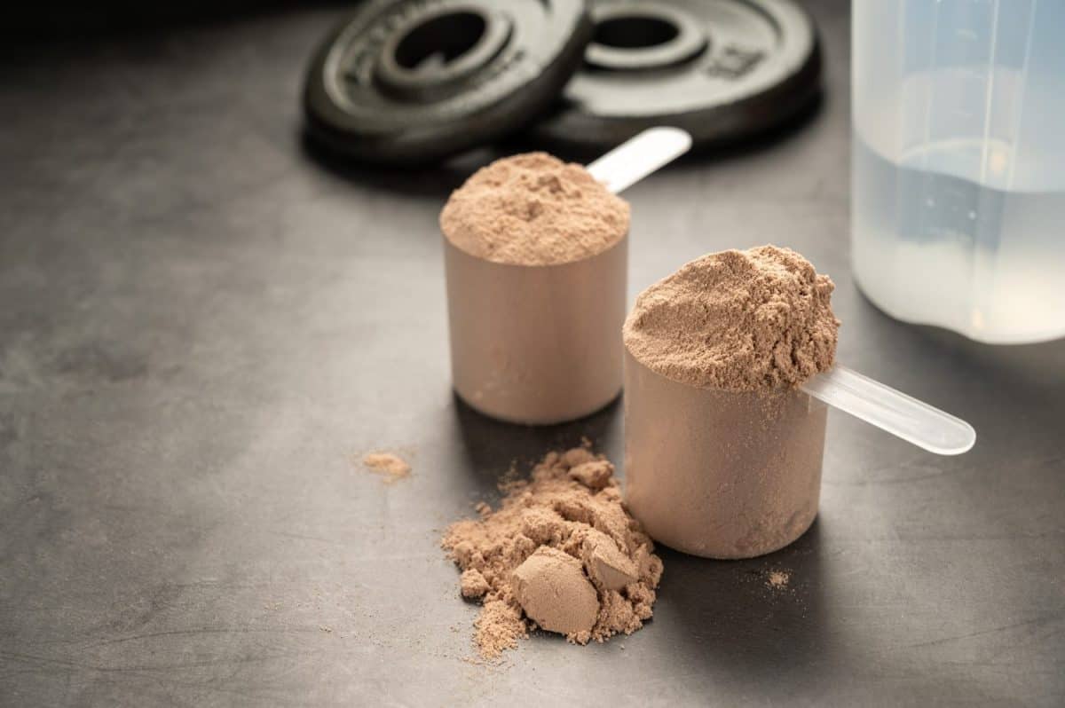 Chocolate protein powder in scoops. Food supplement, nutrition. Ways to make your hair grow