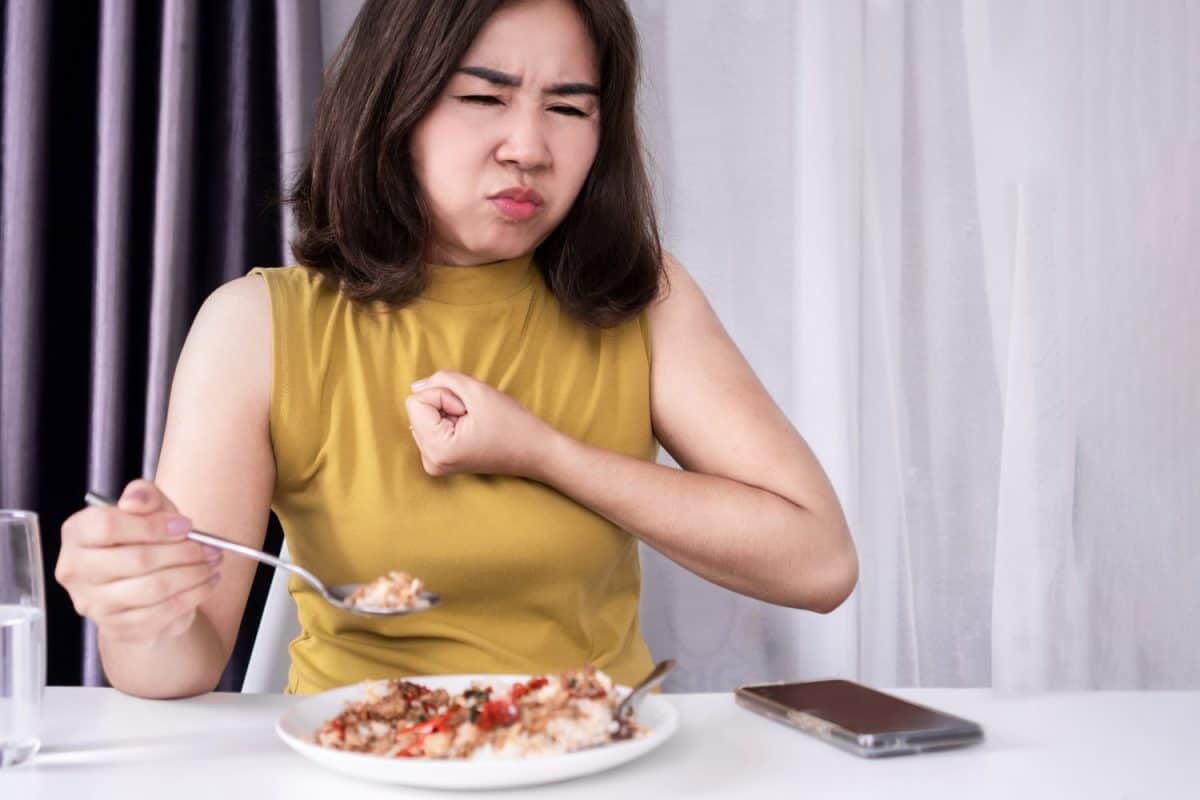 asian woman suffering form choke on food or choking during eating can be used for dysphagia or difficulty swallowing concept