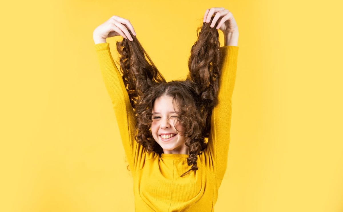 going crazy. happy girl with long windy hair. healthy and strong hair. good shampoo or lotion. hairdresser beauty salon. Strong and healthy hair concept. Small child long hair. kidding around. The best treatment options for lice.