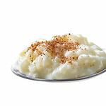 spoon of rice milk pudding with cinnamon isolated on white background. healthy breakfast ideas for busy mornings