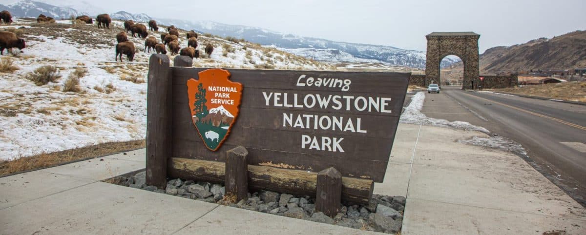 The leaving sign for Yellowstone National Park with iconic Northwest gate. The best U.S. National Parks for viewing animals.