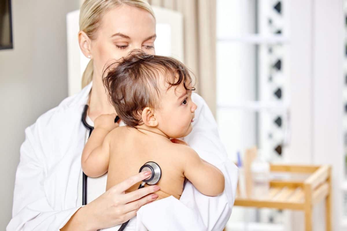 Doctor, baby and listen to lungs in hospital for newborn healthcare, medical appointment and stethoscope on body. Young child, pediatrician and patient exam at clinic for croup, growth and breathing