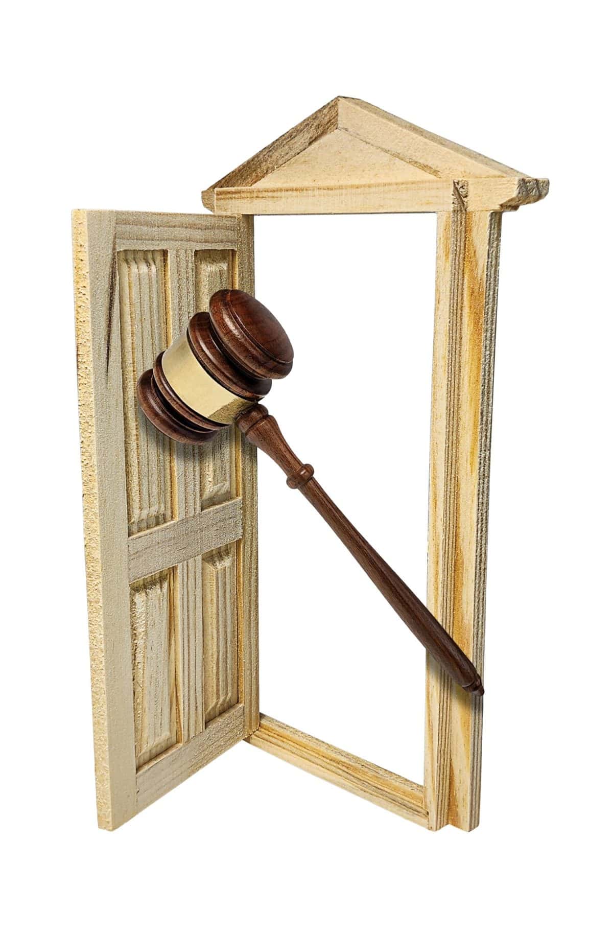 Open Wooden door used to separate rooms with a gavel to show building and construction legal issues