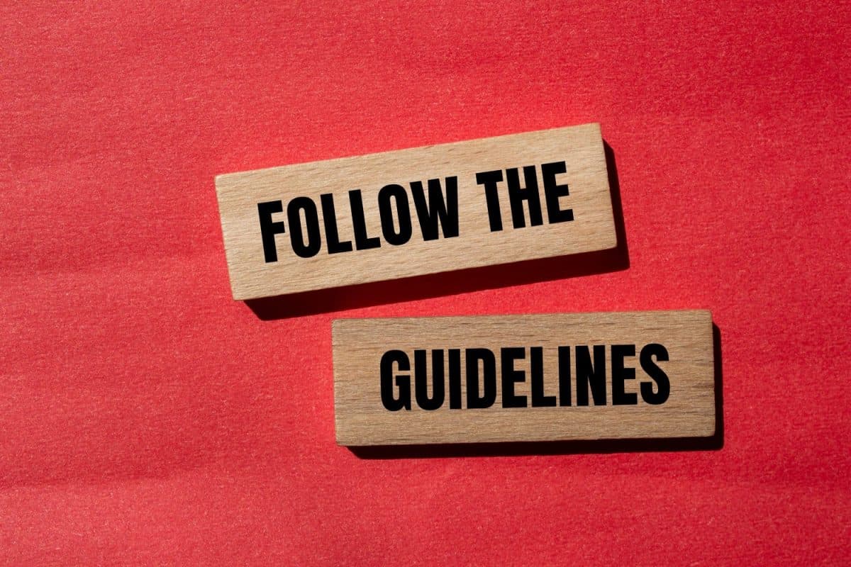 Follow the guidelines words written on wooden blocks with red background. Conceptual follow the guidelines symbol. Copy space. Sheet pan fajitas