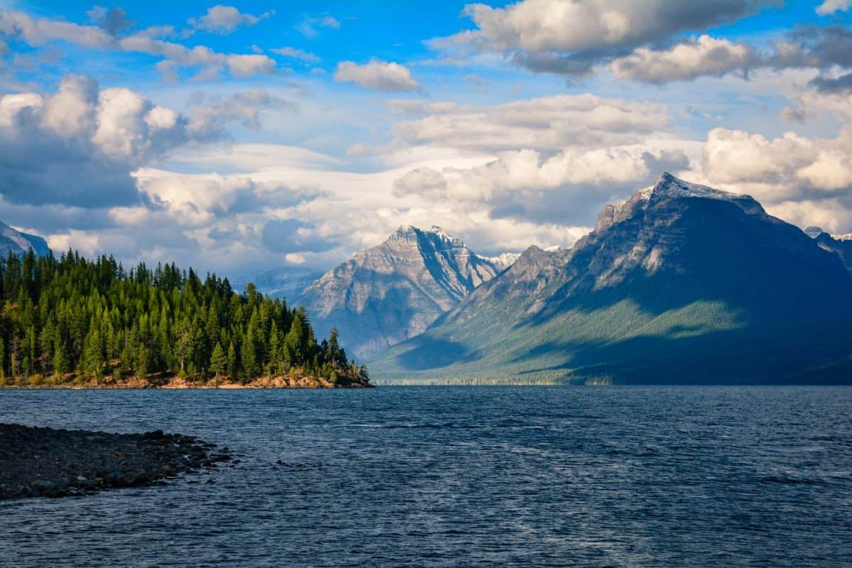 Glacier National Park's Lake McDonald in Montana, USA. Late afternoon in early September. View of Rocky Point, Mount Cannon, and Mount Brown from Fish Creek campground. The best U.S. National Parks for camping.