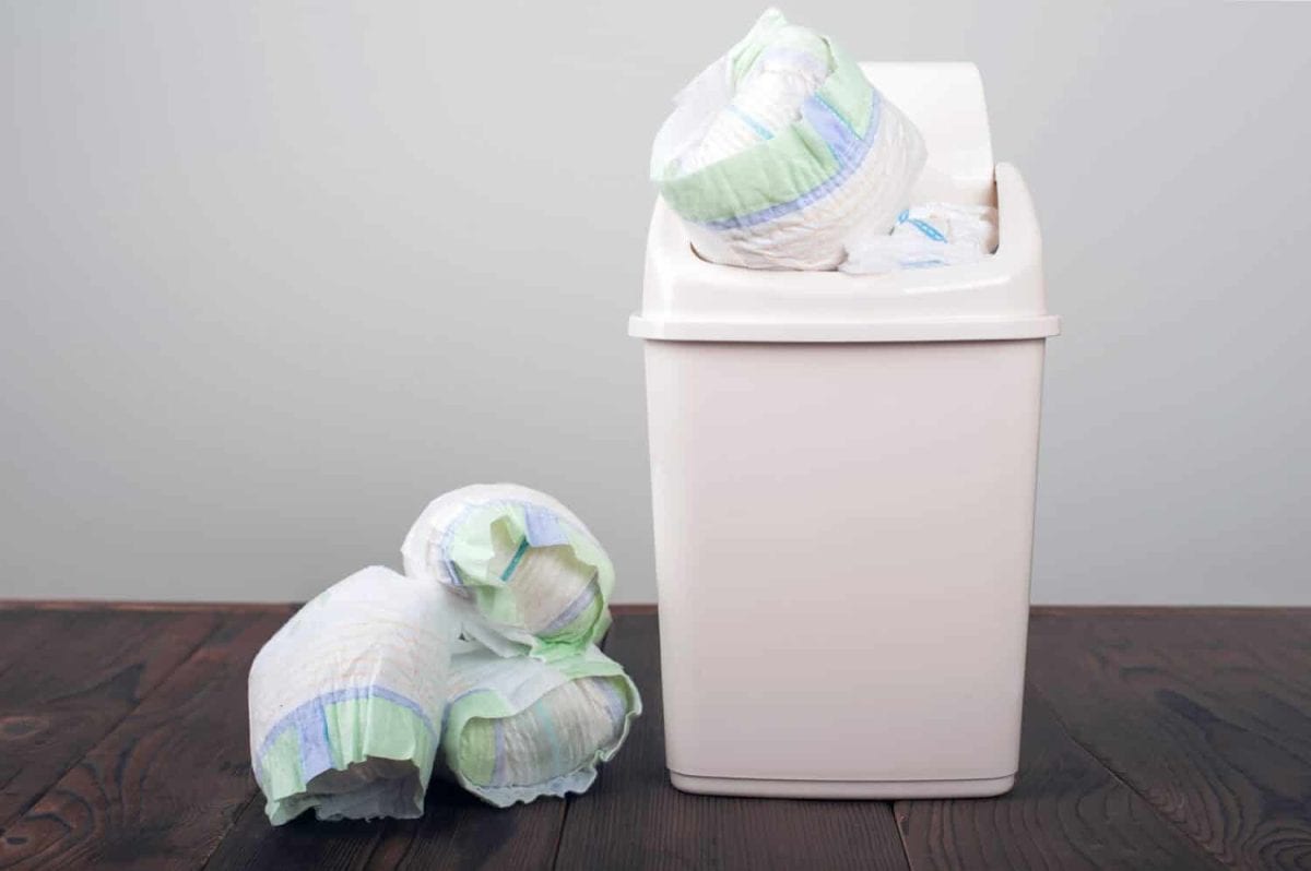 Diapers waste, dirty diapers in garbage pail Disposing of used baby nappies. Environmental Impact of Disposable Diapers. Pollution of the environment, soil and water