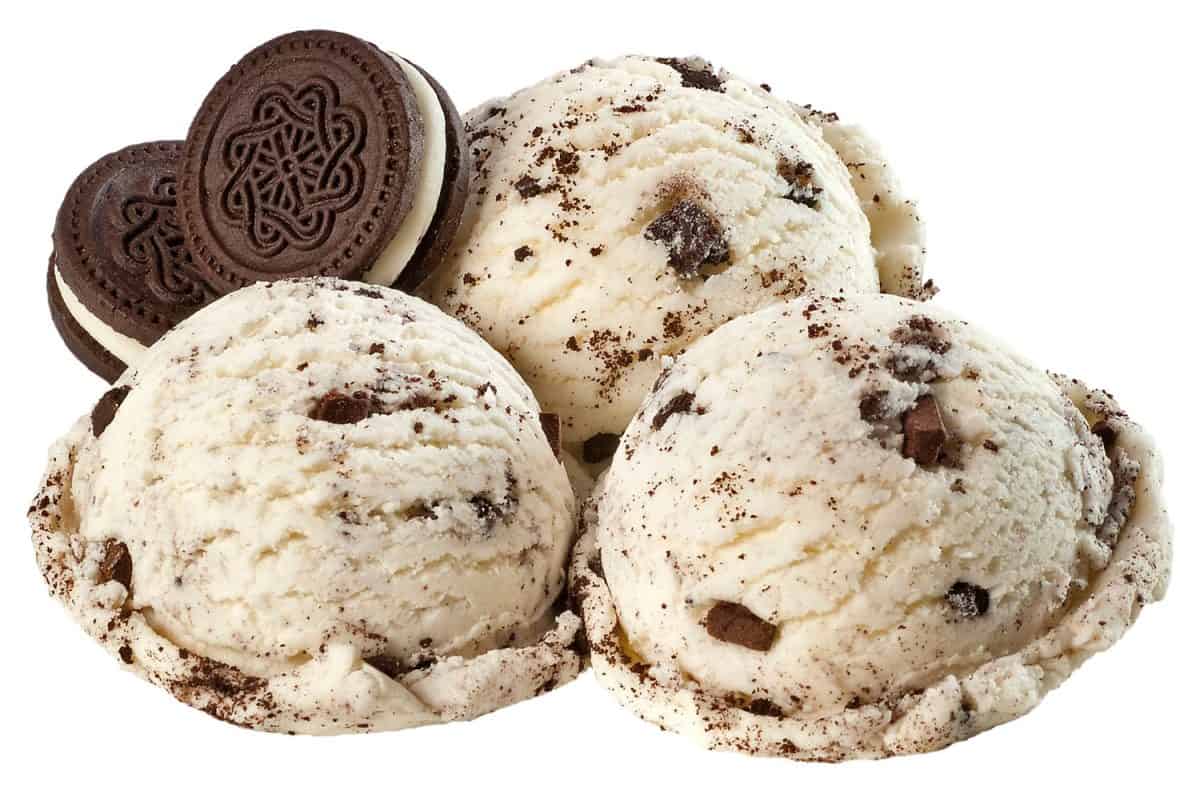 Milk cream ice cream balls composition with insers of small pieces of chocolate and stuffed cookies isolated on white + clipping path.