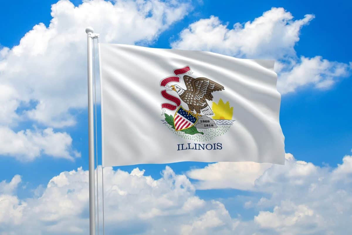 Illinois flag waving in the wind on clouds sky. High quality fabric. International relations concept