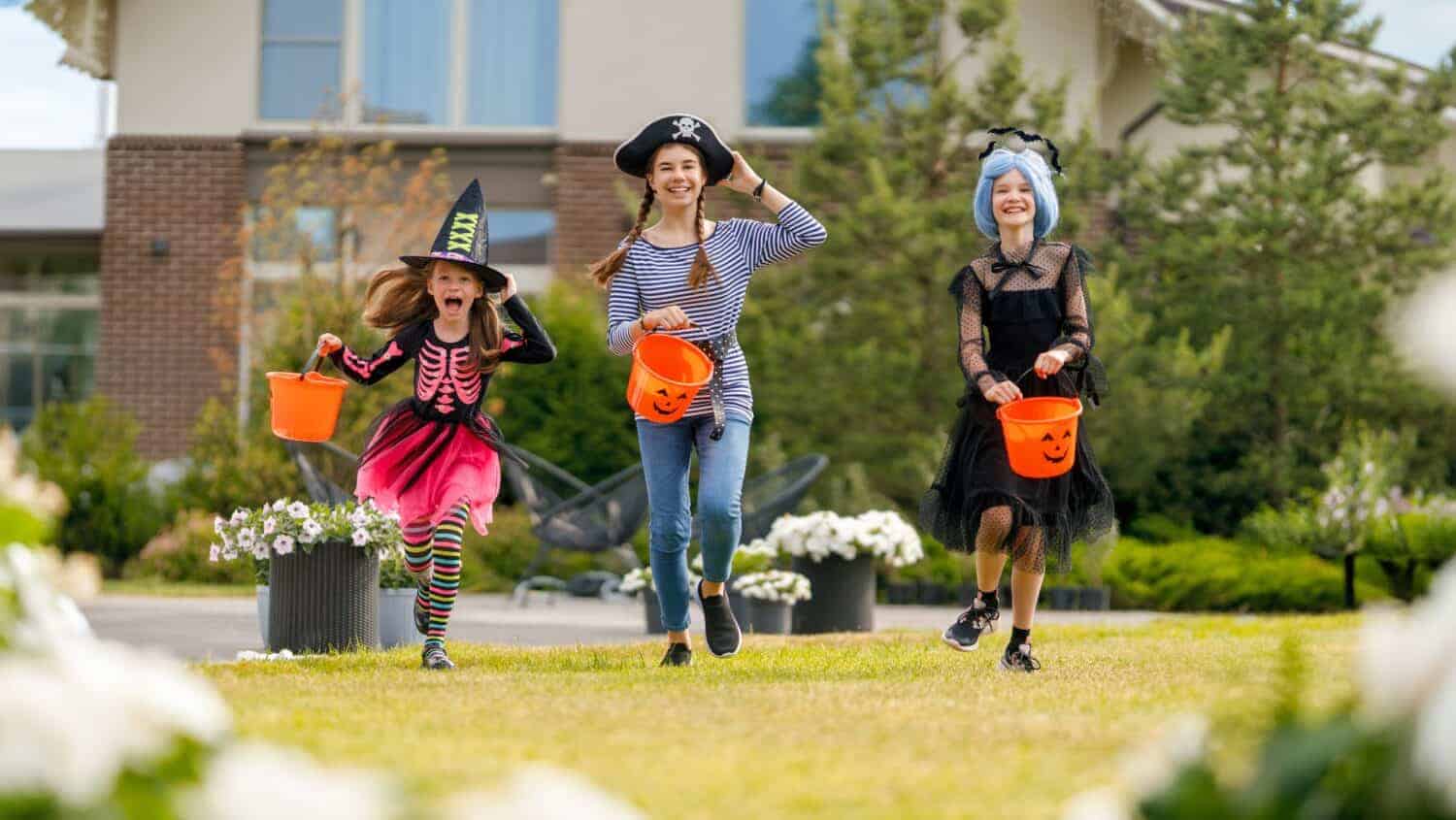 Happy kids at Halloween party. Children are wearing carnival costumes.