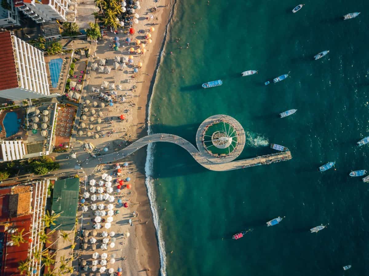 Aerial view of Los Muertos Pier boardwalk at sunset near melecon in Puerto Vallarta Mexico.