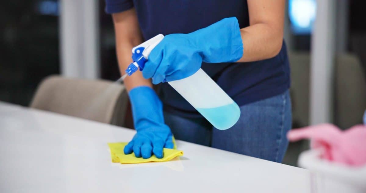 Hands, cleaner and sanitizer for hygiene, fresh and disinfectant for virus protection or housekeeping. Person, worker and spray for bacteria, disease and prevention in office as janitor for company