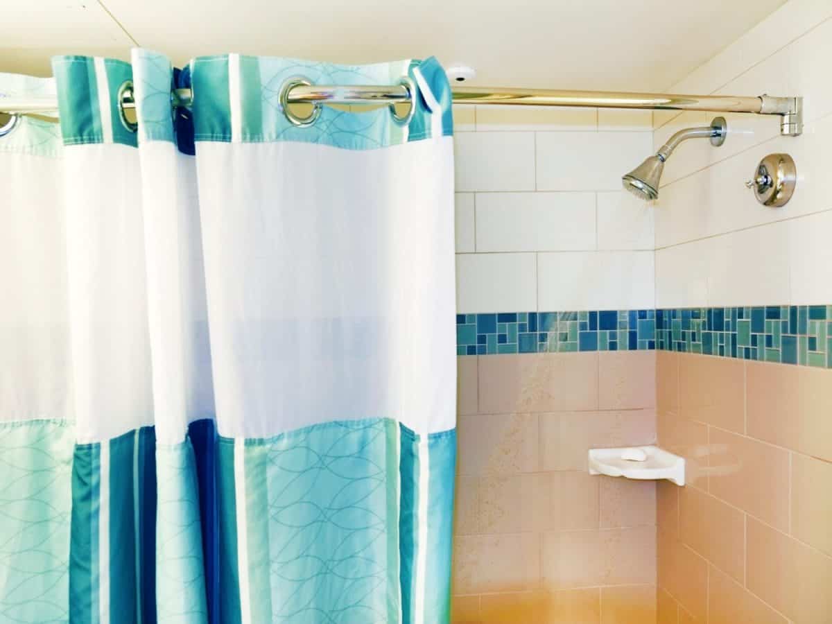 JAKARTA, INDONESIA - July 21, 2024: Shower running with the curtain open in Jakarta, Indonesia on July 21, 2014.