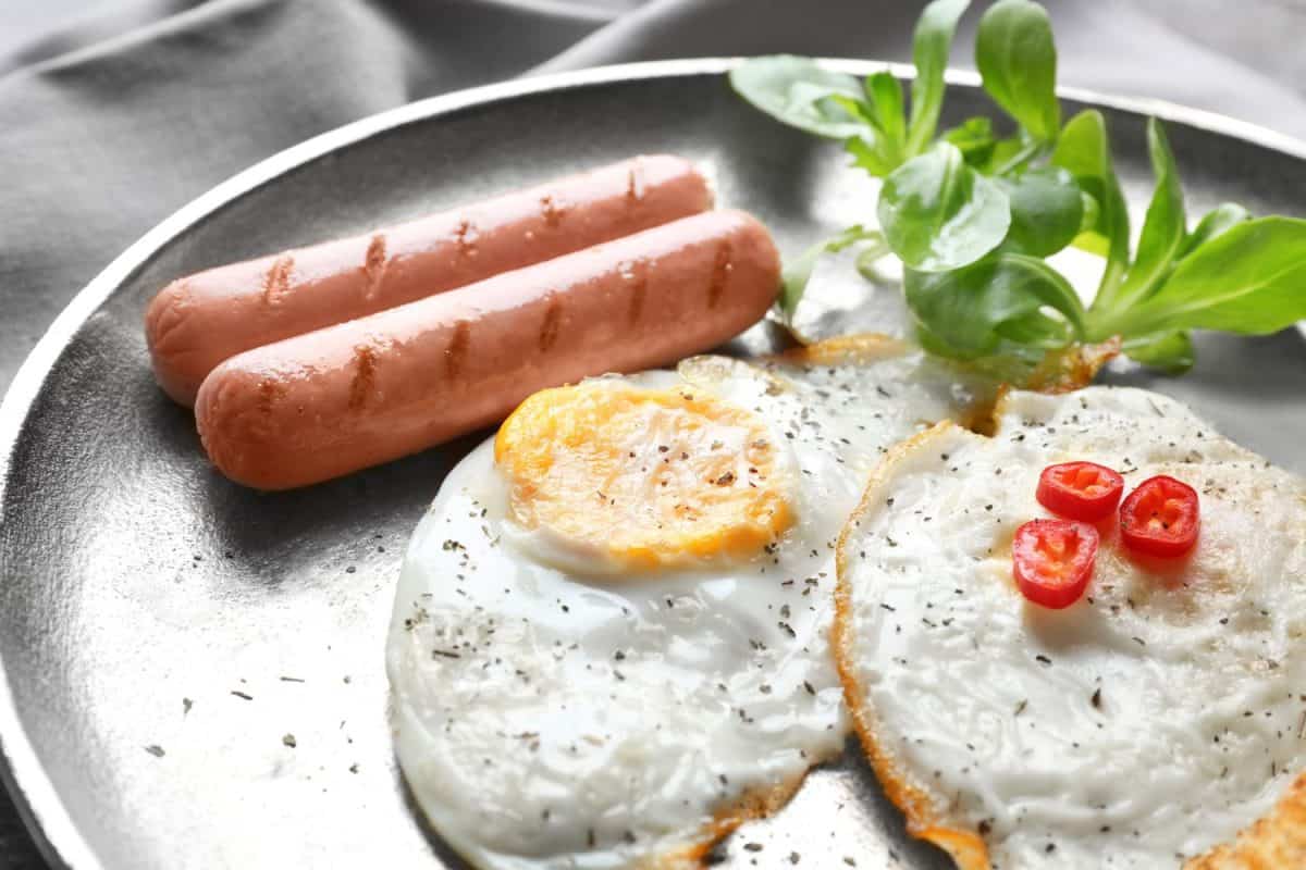 Delicious breakfast with over hard eggs, closeup