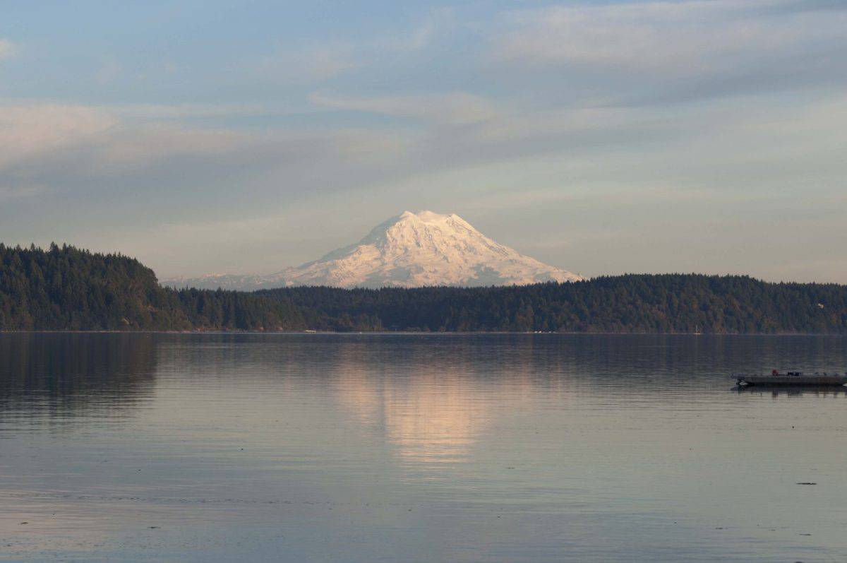 Mount Rainier is reflected in Case Inlet photographed from Harstine Island, WA, USA.