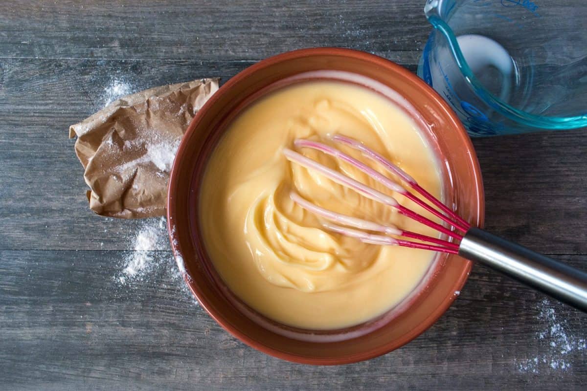 top view mixing ingredients for making vanilla pudding