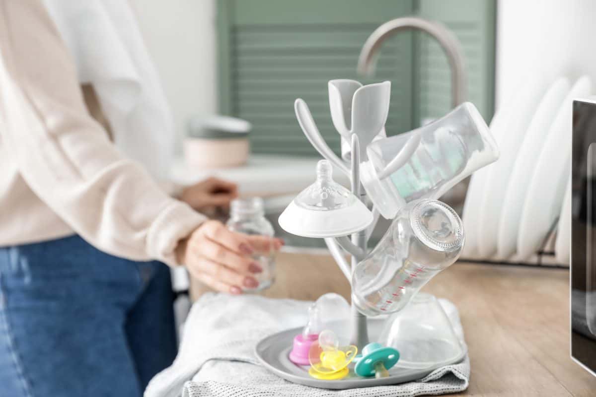 Drying rack for baby bottles on table in kitchen