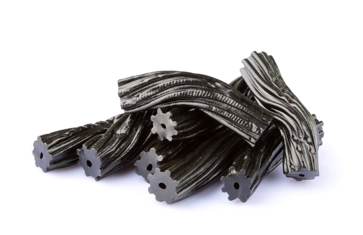 Black licorice candies isolated on white background