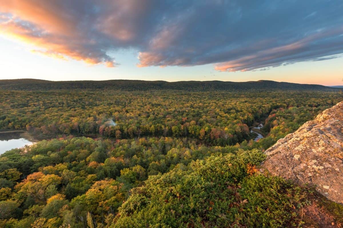 The Big Carp River cuts a swath through an autumn colored forest. Viewed from a rocky bluff on a hiking trail at Porcupine Mountains Wilderness Area, in Michigan's Upper Peninsula