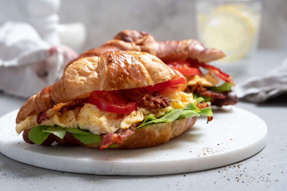 BLT bacon lettuce tomato sandwich croissant with scrambled egg