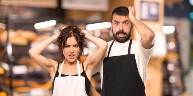 Couple of cooks takes hands on head because has migraine