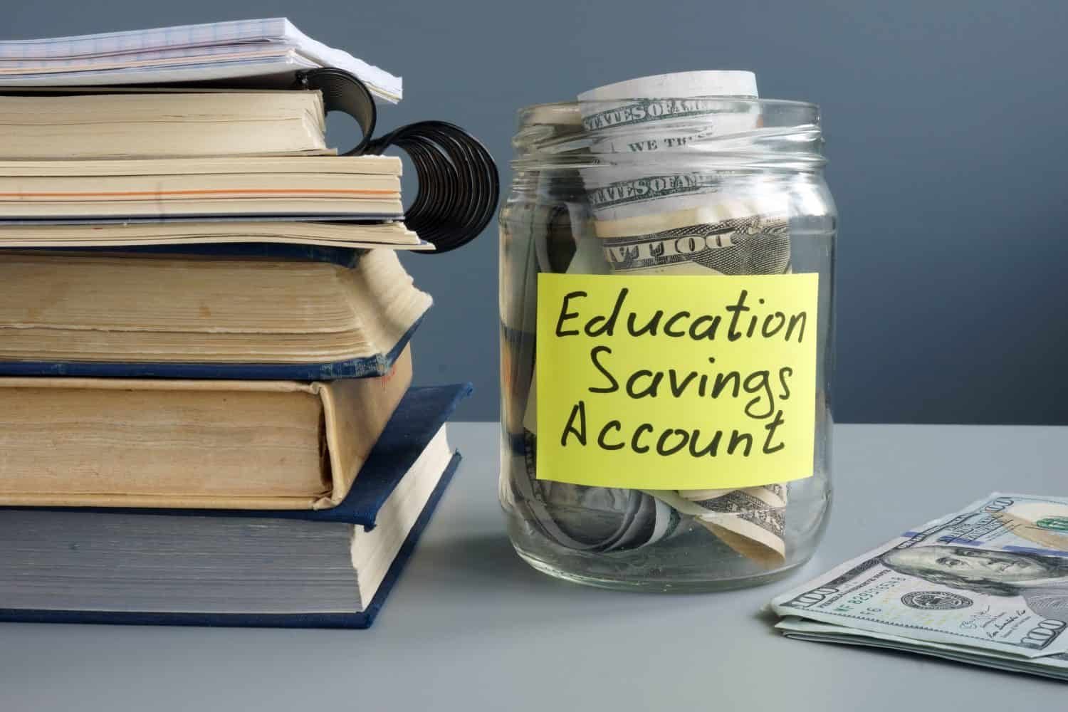 ESA Education Saving Account label on jar with money and books.