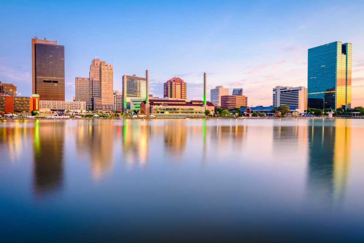 Toledo, Ohio, USA downtown skyline on the Maumee River at dusk.