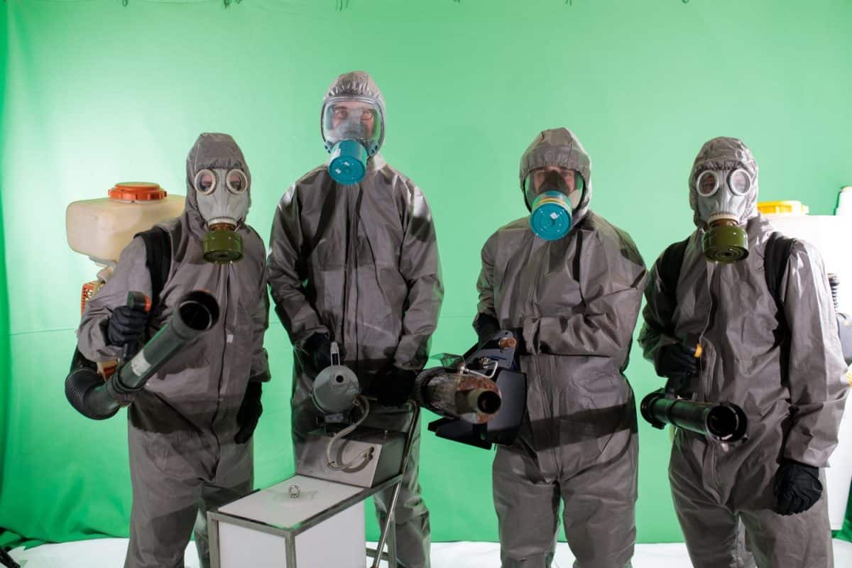 Quarantine cleaning team in respirators with equipment against covid 19 with green chromakey background. ghostbusters