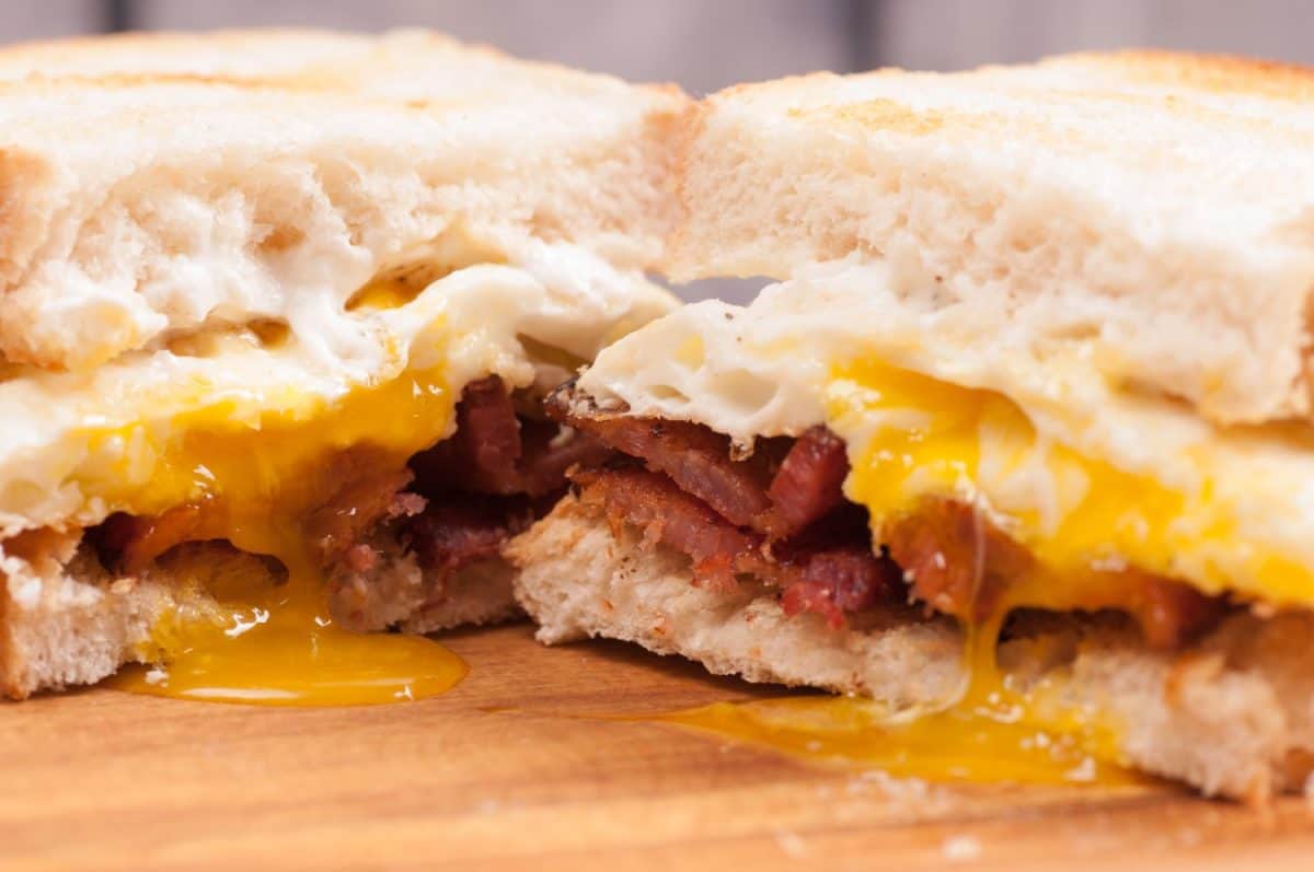 eggs, bacon and cheve cheese breakfast sandwich with pan fried potatoes