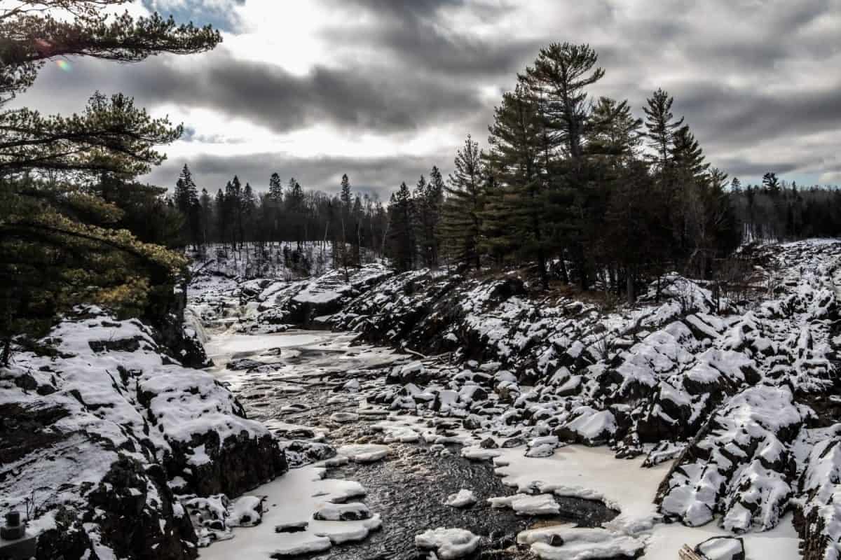 Rocky shoreline in winter along the St. Louis River in Jay Cooke State Park, Carlton, Minnesota.