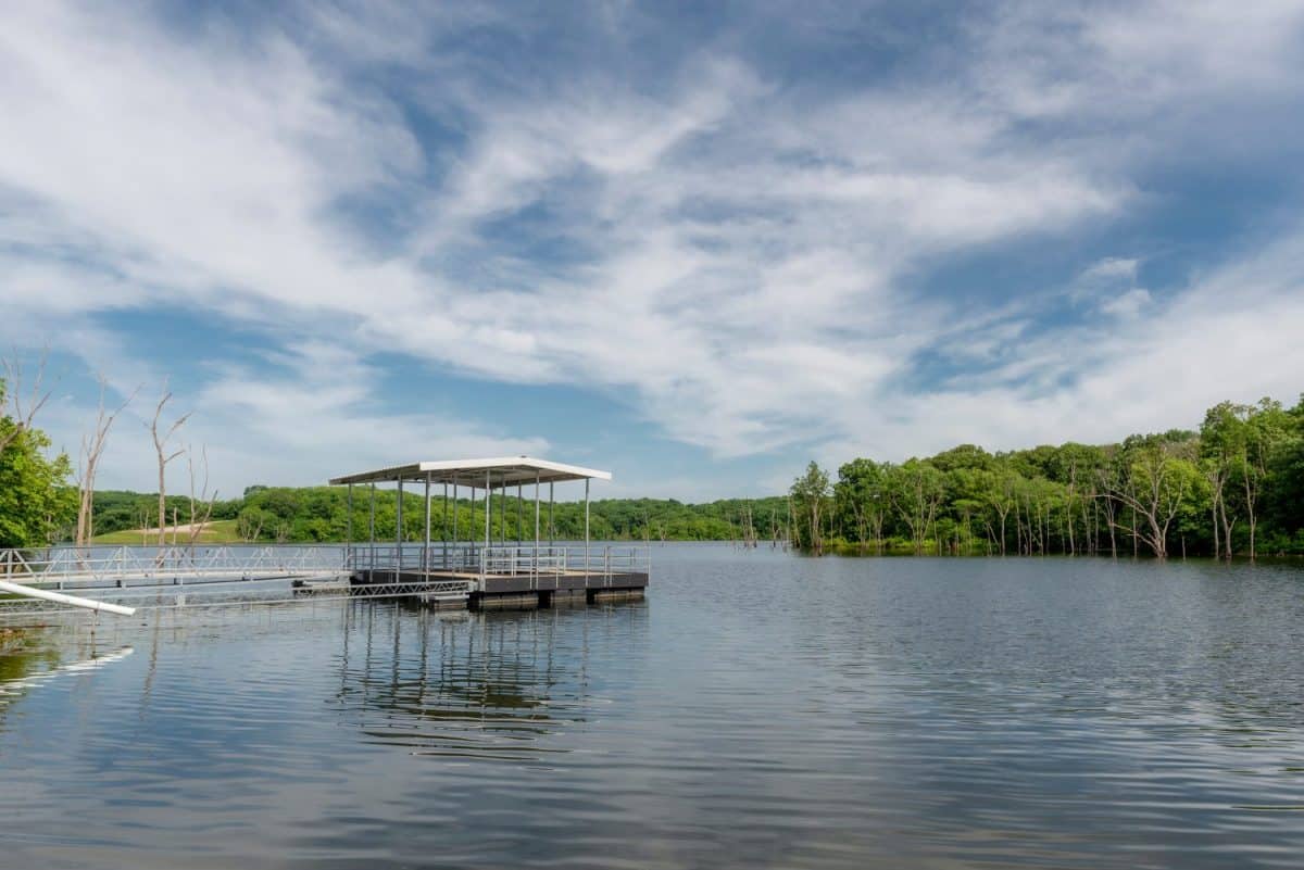 Empty fishing pier on Indian Creek Lake public use area. Empty fishing lake in Missouri in the morning. Relaxing outdoor recreational area with no people.