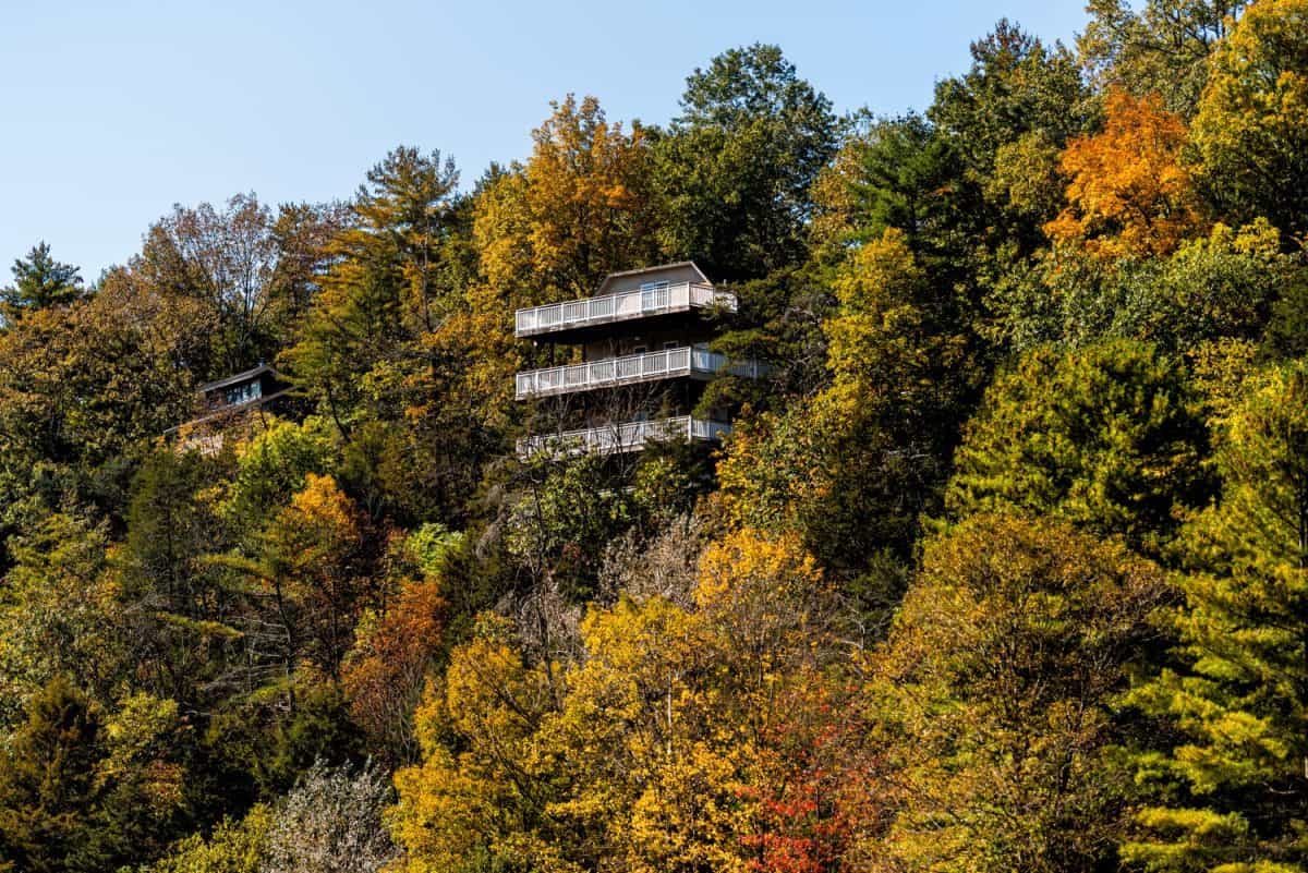 Cliff residential houses homes buildings architecture on mountain edge in Basye, Virginia rural countryside town in Shenandoah county in autumn fall with balcony patio terrace