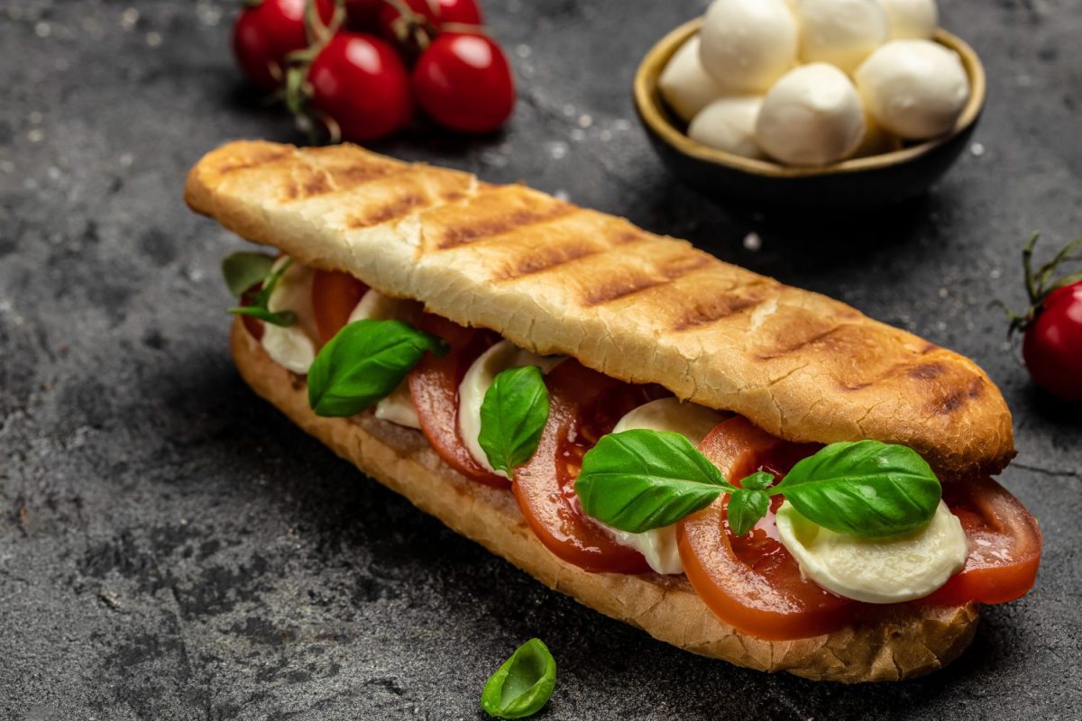 Healthy Grilled Basil Mozzarella Caprese Panini Sandwich. Delicious breakfast or snack, Clean eating, dieting, vegan food concept. top view.